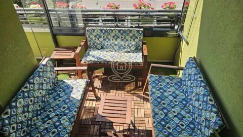 Smaller enclosed balcony furnished with seating sets and wooden flooring. - image 17