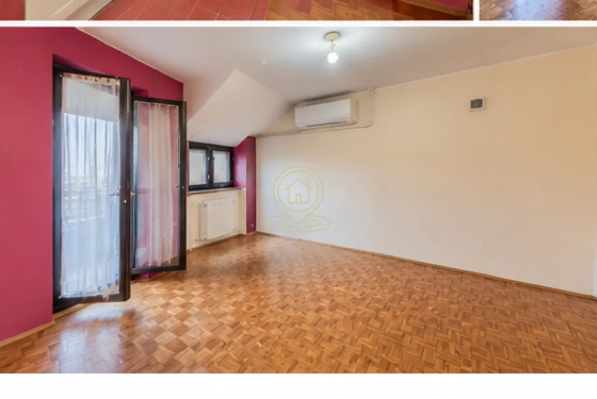 Prazna soba sa parketom i izlazom na balkon.