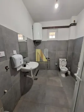 Modern bathroom with grey tiles, washbasin, and toilet. - image 23