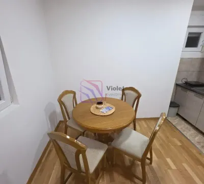Dining table with four chairs as part of the kitchen area. - image 4