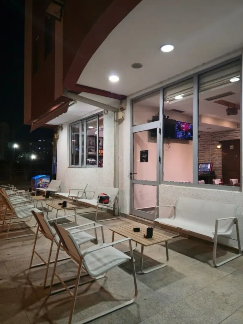 Exterior of the commercial space with tables and chairs set up.
