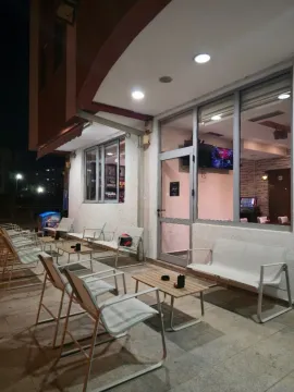 Exterior of the commercial space with tables and chairs set up. - image 3