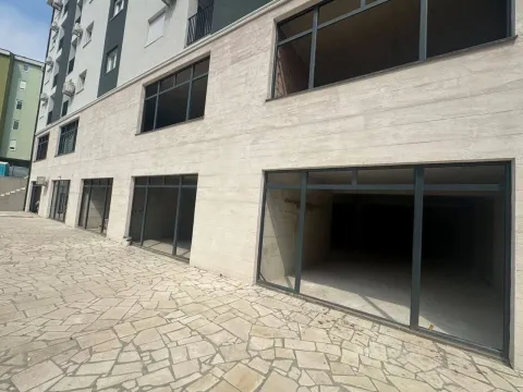 Exterior of a ground-floor commercial space in a residential building with large glass surfaces. - image 9