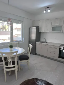 Bright kitchen with a dining area and modern elements. - image 2