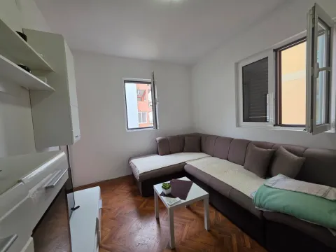 Living room with a corner sofa, coffee table, and parquet flooring. - image 22