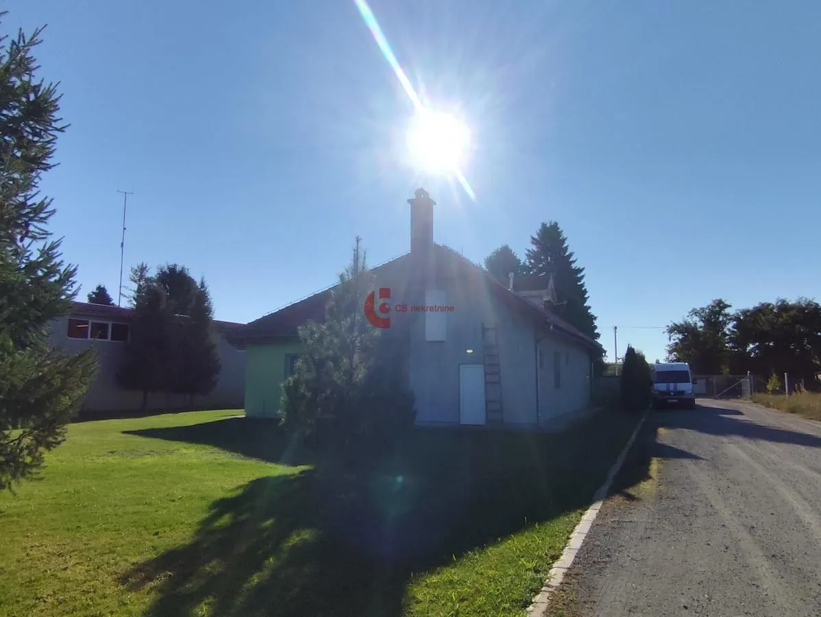 Exterior view of the house with a yard and driveway.