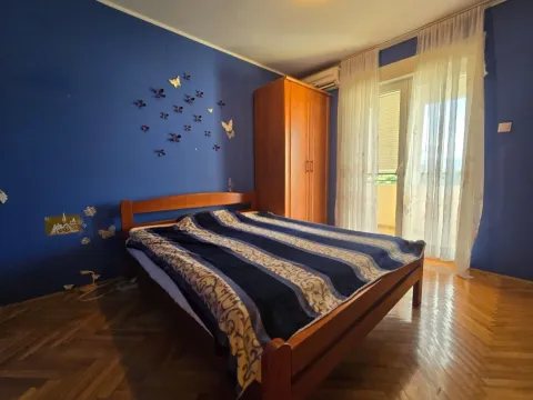 Bedroom with a double bed, wooden wardrobe, and a blue accent wall. - image 7