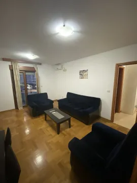 Living room with blue furniture and parquet flooring. - image 4