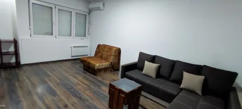 Living room with a sectional sofa, an armchair, and laminate flooring. - image 14