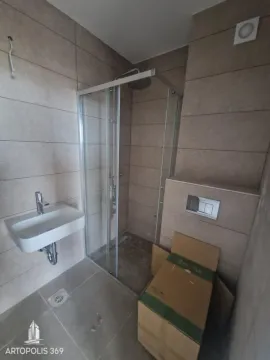 Bathroom with a shower cabin, washbasin, and tiled walls. - image 17