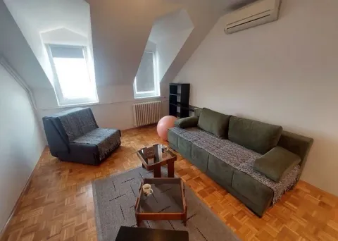 Attic living room with sofa set and parquet flooring. - image 2