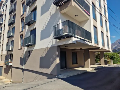 Exterior of a modern residential building with balconies and driveway. - image 10