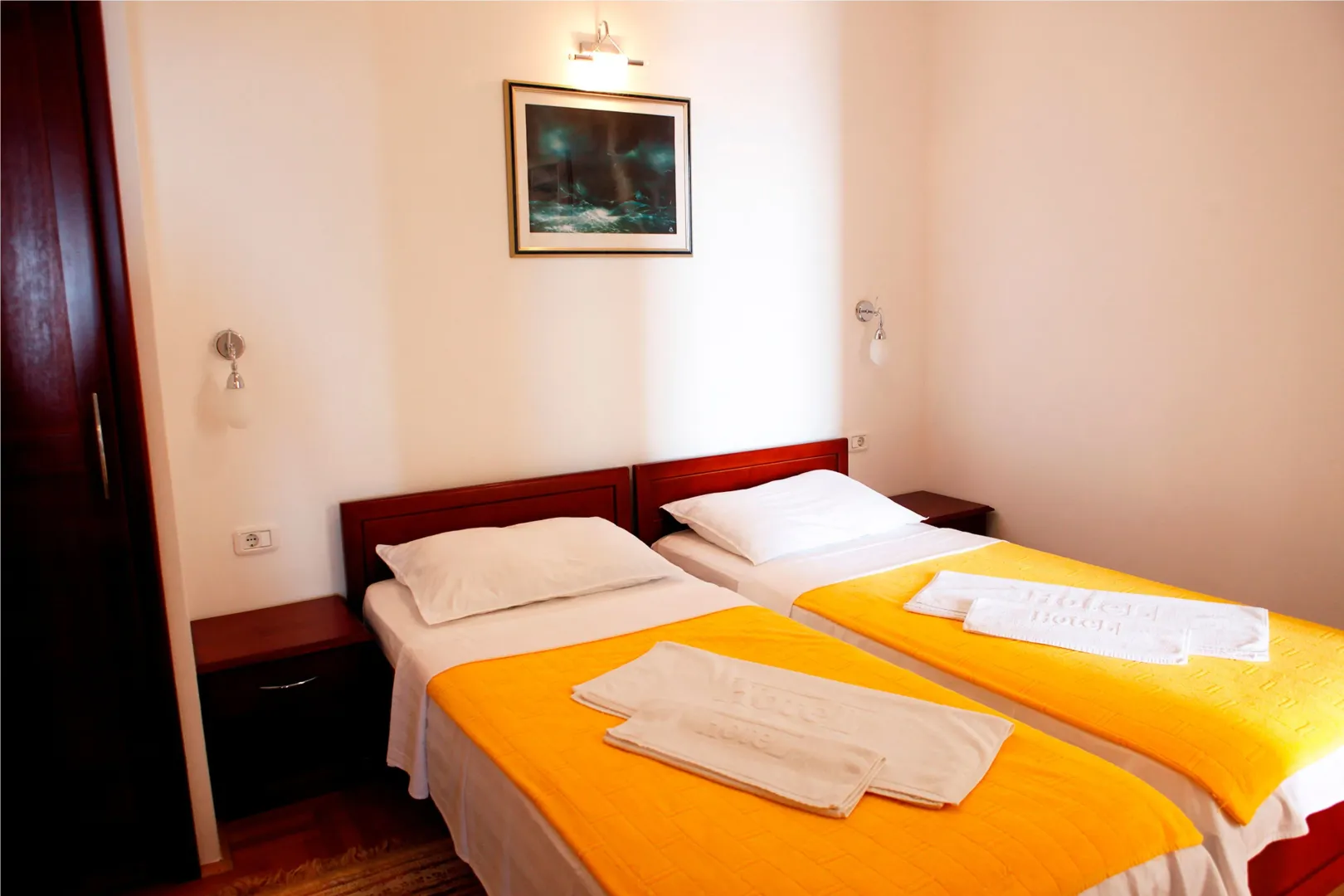 Bedroom with two single beds and bedside tables.