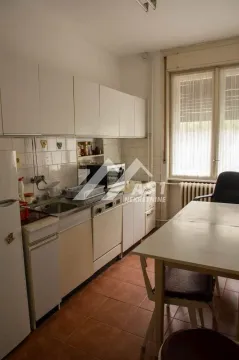 Kitchen with white cabinetry and a dining table. - image 2