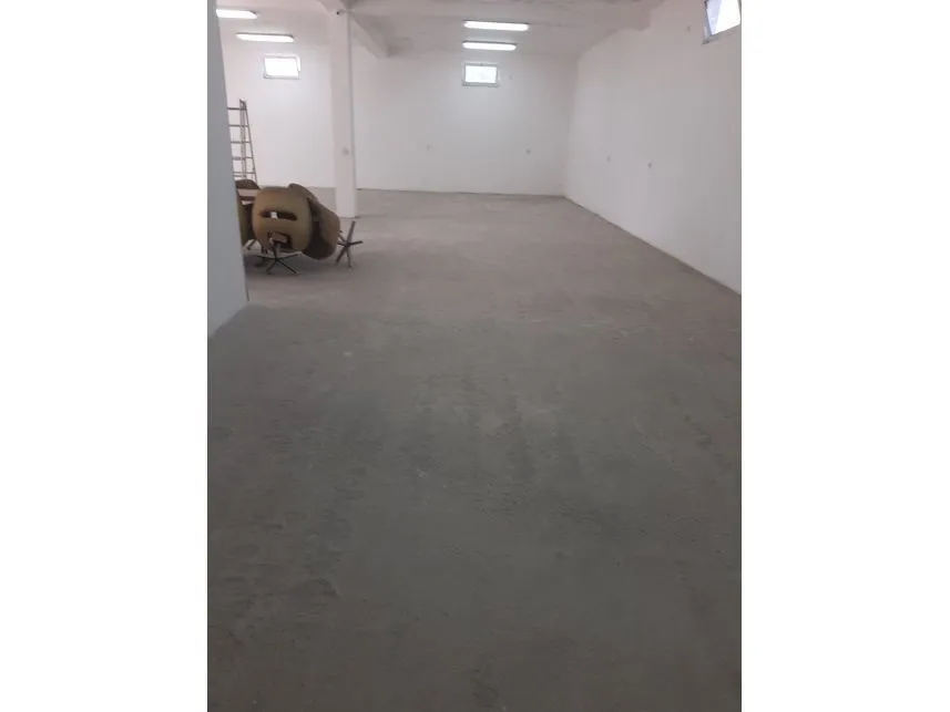 Spacious and empty indoor space with a concrete floor.