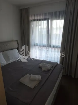 Furnished bedroom with a double bed and a window covered with curtains. - image 10