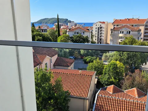 View from the terrace overlooking surrounding buildings and the sea. - image 4