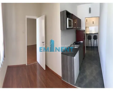 Small kitchen with dark cabinets and a dining area in the extension. - image 7