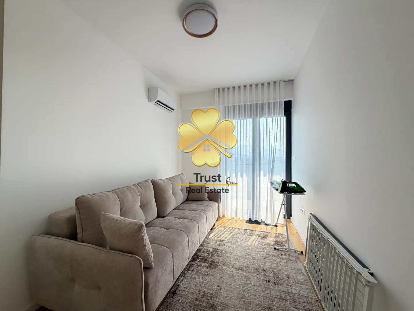 Bright living room with a sofa and access to the terrace.