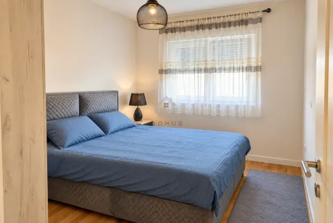 Furnished bedroom with a double bed, window, and nightstand. - image 4