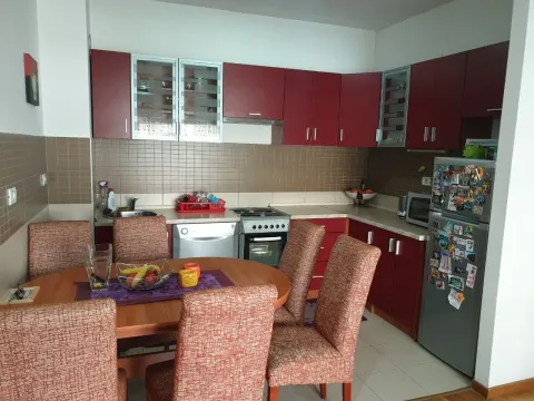 Kitchen with red cabinets and an adjacent dining area. - image 2