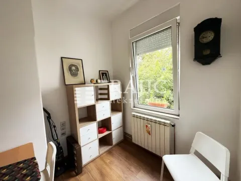Small room with a desk, shelving unit, and a window. - image 6