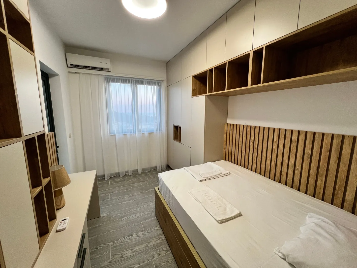Modern bedroom with a bed and built-in wardrobes.
