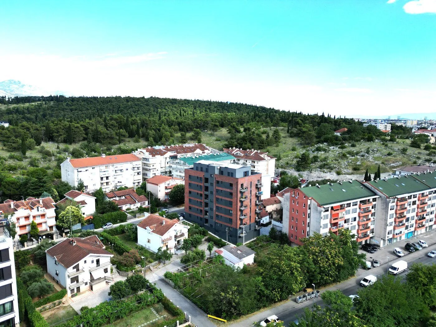 Aerial view of residential buildings and the surrounding neighborhood.