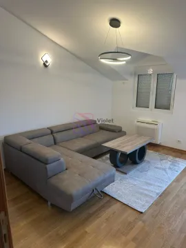 Living room with a sectional sofa, coffee table, and rug. - image 5