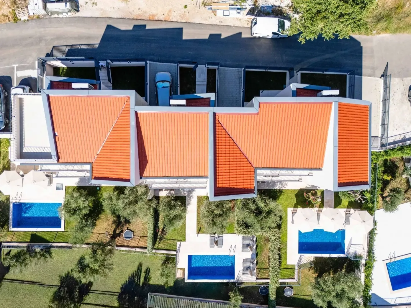 Aerial view of a residential complex with swimming pools and yards.