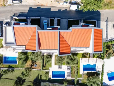 Aerial view of a residential complex with swimming pools and yards. - image 13