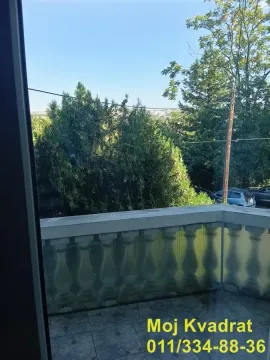 View from the tiled terrace onto green trees and surroundings. - image 7