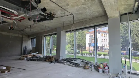 Unfinished commercial space under construction with large glass surfaces and street view. - image 20