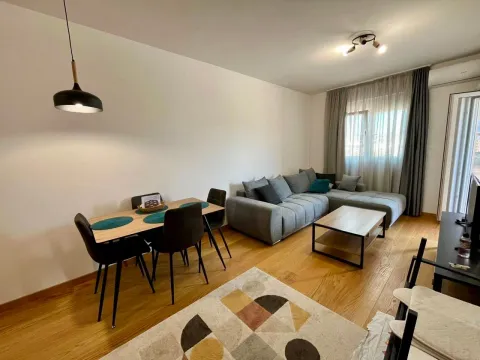 Living room with a sectional sofa, dining table, and access to the terrace. - image 4