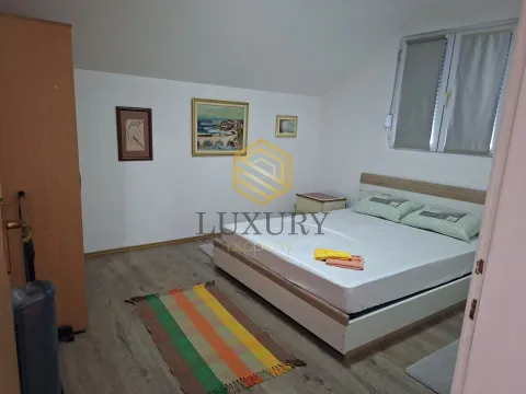 Bedroom with a double bed, wardrobe, and paintings on the wall. - image 4