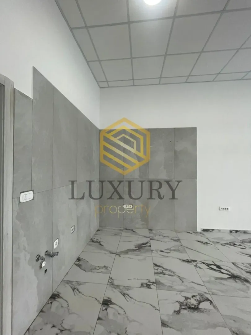 Empty room with wall and floor tiles.