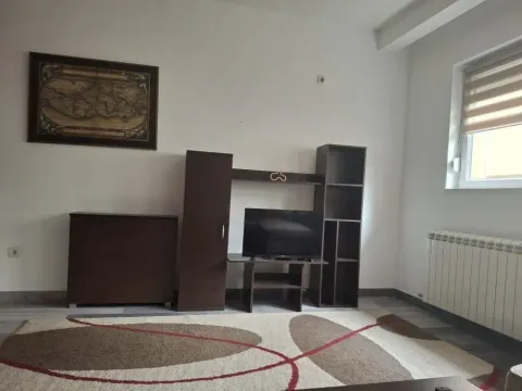 Living room with dark wooden furniture, television, and a rug. - image 7