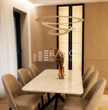 Modern dining room with a marble table, beige chairs, and a decorative chandelier. - image 10