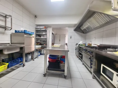 Commercial kitchen with professional stainless steel equipment. - image 11