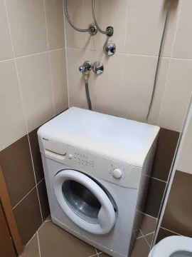 Bathroom with a washing machine and ceramic tiles. - image 7