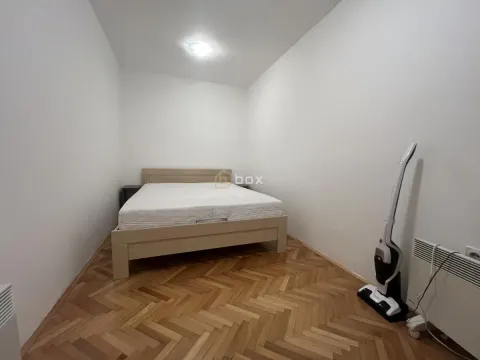 Bedroom with a double bed and parquet flooring. - image 11
