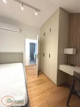 Furnished bedroom with a built-in wardrobe and a desk. - image 15