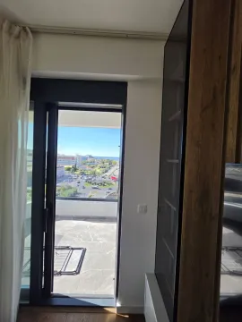 View through the balcony door to the terrace and surroundings. - image 12