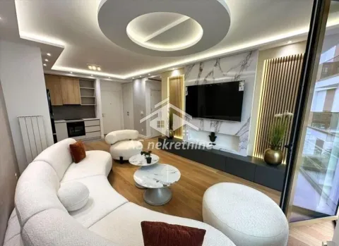 Modern living room with a sofa set and built-in elements, connected to the kitchen. - image 2