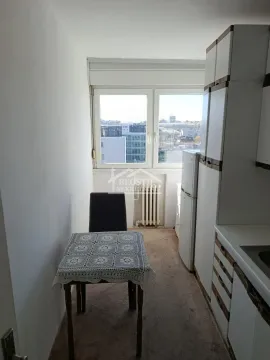 Manja kuhinja sa trpezarijskim stolom i prozorom koji gleda na grad. - image 11
