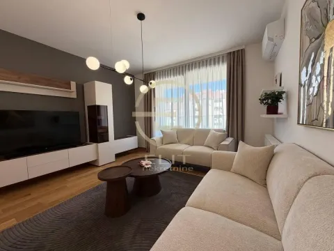 Comfortable living room with sofa, TV, and modern lighting. - image 26