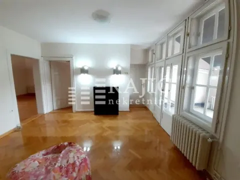 Empty room with parquet flooring and large windows. - image 13