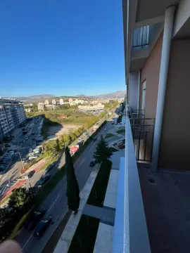 View from the balcony of the city street and surrounding buildings. - image 13