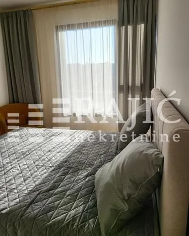 Furnished bedroom with a double bed and a window.