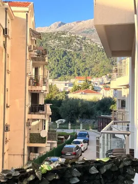 Pogled sa terase na okolne zgrade, ulicu i planine u pozadini. - image 9